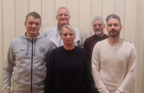 Ein vereintes Team des Jahres, das stolz seine Auszeichnung präsentiert, die Engagement, Teamarbeit und hervorragende Leistungen symbolisiert.